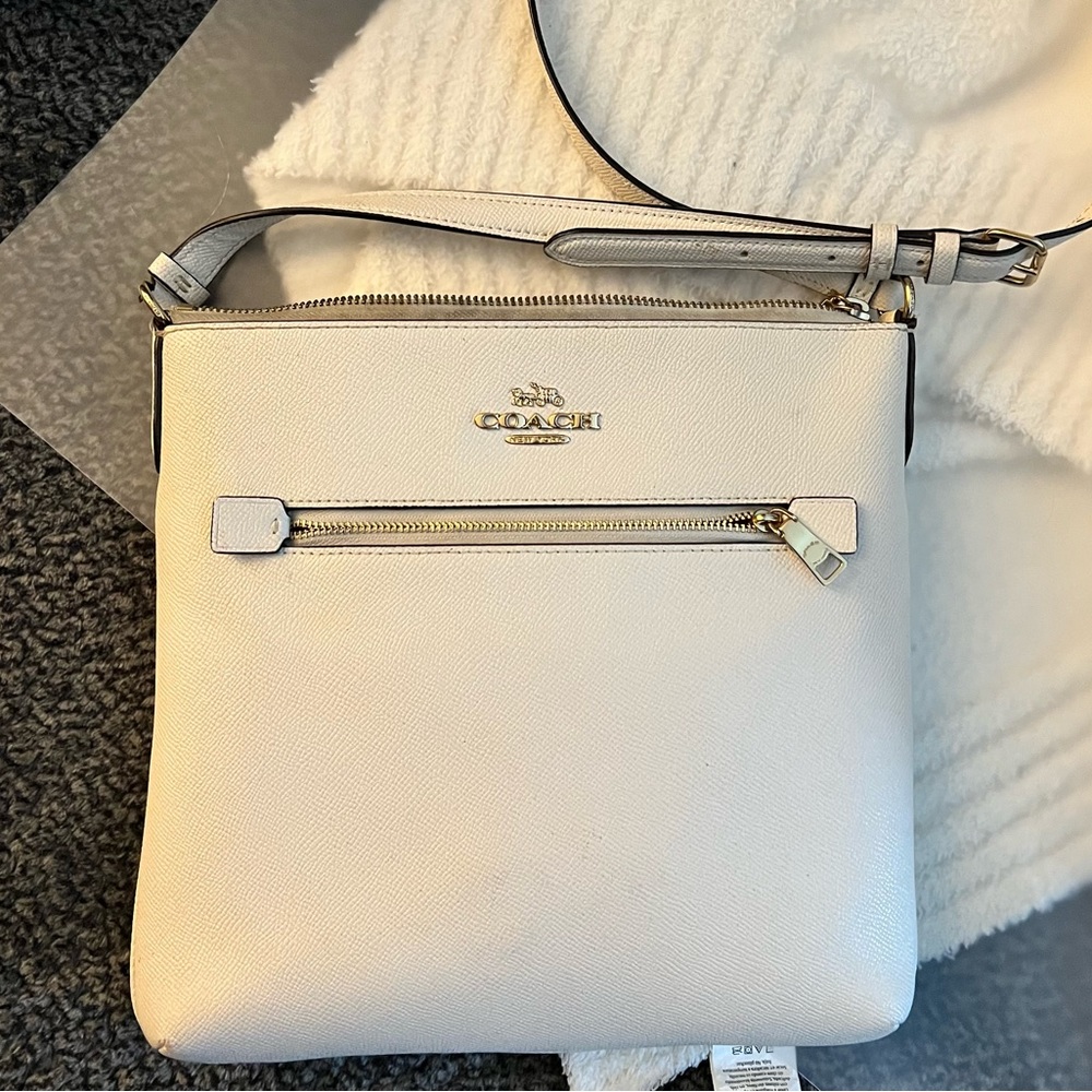 Coach crossbody in white and gold.